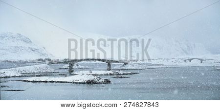 Fredvang bridges in heavy snowfall in winter. Lofoten islands, Norway