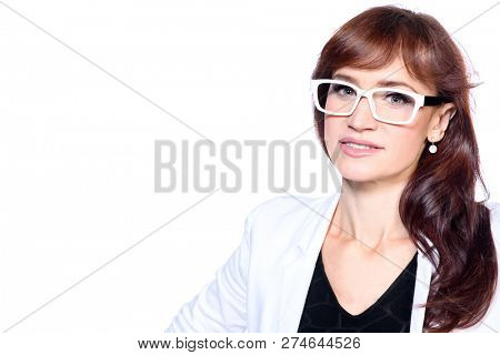 A close up portrait of a beautiful woman wearing classic clothes and posing over the white background in the studio. Beauty, fashion, business.
