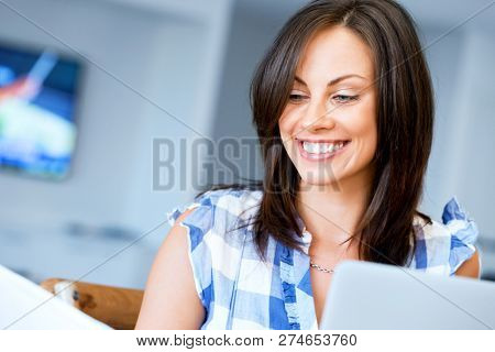 Woman with papers in their living room