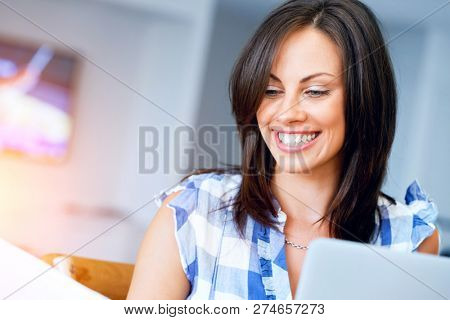 Woman with papers in their living room