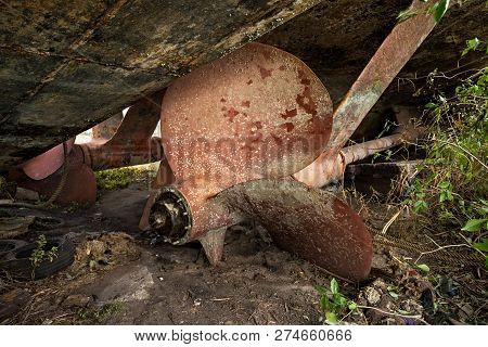 Huge Bronze Screw Of The Abandoned On The Shore Of A Warship.