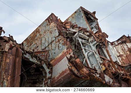 Huge Rusty Pieces Of Decommissioned Marine Ship That Was Cut And Left On The Shore.