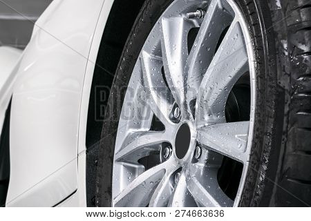 Cars In A Carwash. Car Wash With Foam In Car Wash Station. Carwash. Washing Car Wheel At The Station