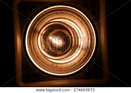 A Light Bulb Barely Lit In A Vintage Style Lamp