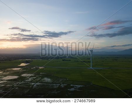 Wind Turbine Farm Or Windmill On Blue Sky. Turbine Green Energy Electricity Or Wind Turbine In A Gre