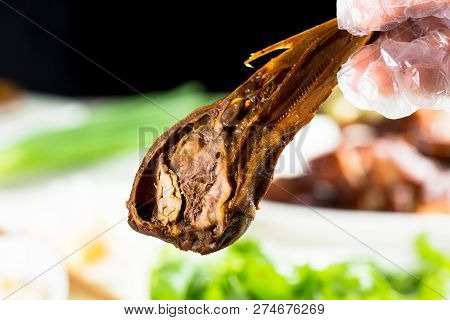 Duck Head With Marinated Sauce On The White Dish