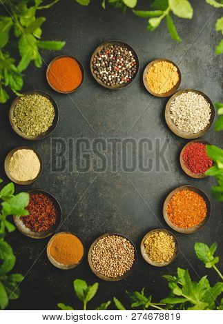 Various bowls of spices over dark background