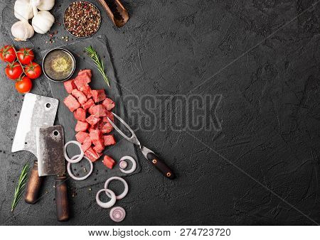 Raw Lean Diced Casserole Beef Pork Steak With Vintage Meat Hatchet And Fork On Stone Background. Sal