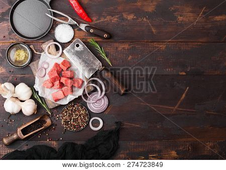 Raw Lean Diced Casserole Beef Pork Steak With Vintage Meat Hatchet And Fork On Wooden Background. Sa