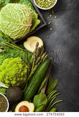 Assorted Green Toned Raw Organic Vegetables On Dark Background. Avocado, Cabbage, Broccoli, Cauliflo
