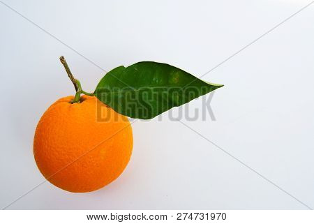 One Fresh Orange With Petiole And Leaf On A White Background