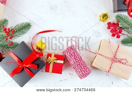 Christmas Decorative Background With Fir Branches, Cones, Redr And Black Christmas  Gifts, Ball On T