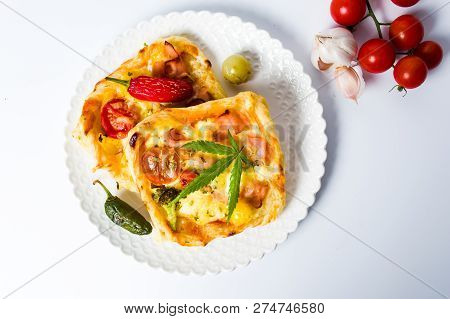 Pizza Pastry Slices With Marijuana On A Plate Top View