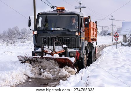 Obrenovac, Serbia - December 16, 2018: The Snow Removal Machine Cleans The Street In The Rural Area 