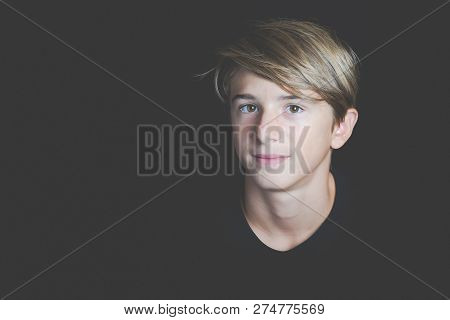 Young Smiling Boy Portrait On Black Background - Concept Of Adolescence Whithout Problems