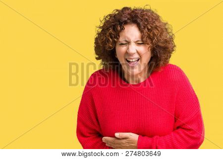 Beautiful middle ager senior woman red winter sweater over isolated background Smiling and laughing hard out loud because funny crazy joke. Happy expression.