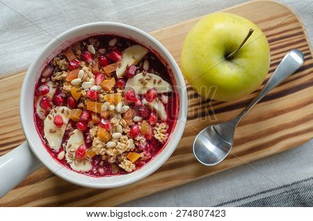 Smoothie Acai Bowl Topped With Pomegranate, Bananas, Flaxseeds, Cedar Seeds, Dried Apricot And Grano