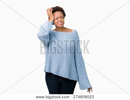 Young beautiful african american woman wearing a sweater over isolated background suffering from headache desperate and stressed because pain and migraine. Hands on head.