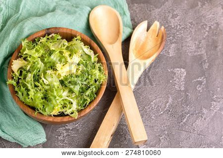 Fresh Frisee Salad In Wooden Bowl. Healthy Food