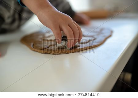 Closeup View Of Toddler Child Hand Making Cookies Pressing Star Shape In A Rolled Dough.