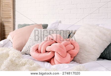 Different Pillows On Bed In Room. Idea For Interior Decor With Living Coral Color