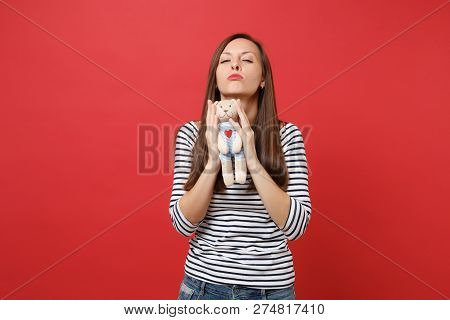Portrait Of Stunning Young Woman In Casual Striped Clothes Holdi