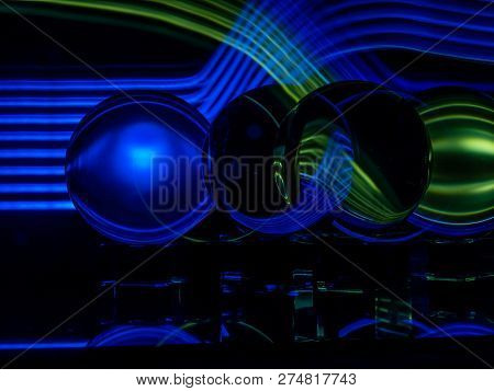 Blue And Green Waves With A Ghosted Lensball Long Exposure Image.