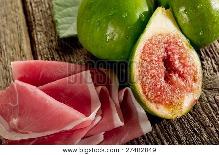 parma ham and slice fig on wood background