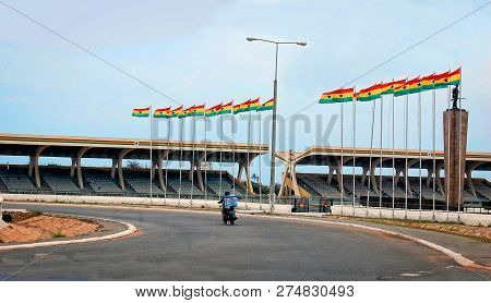 The Accra Sports Stadium With Ghanaian Flags In Background. National Flags On Flagpoles. Football. C