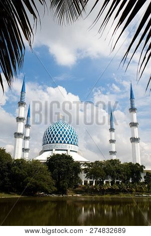 View Of The Blue Mosque During The Day Framed By Coconut Leaf