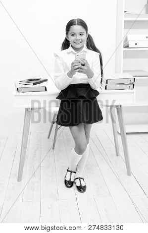 Always In Touch. Kid Girl Send Message To Parents. Schoolgirl Awkward Smiling Face Has Bad News. Gir