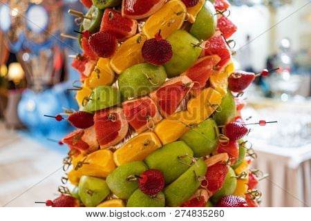 Tropical Fruits Cut Thtower Of Chopped Tropical Fruits And Strawberries At The Banquet. Appetizer At