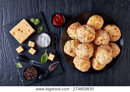 Gougeres, Cheese Puffs Balls On A Black Plate. Traditional French Cheese Choux Buns. Ingredients And