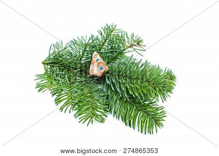 Fir Tree Branch With Christmas Cookie On White