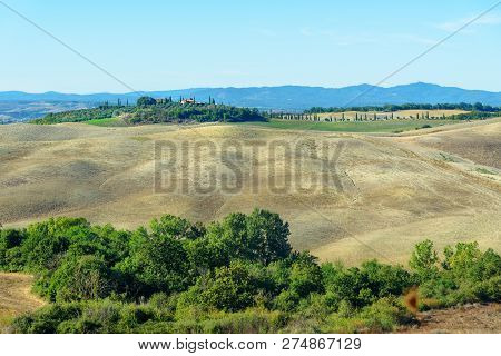 View Of Beautiful Landscape Of Hills And Fields Near Asciano In Tuscany, Italy