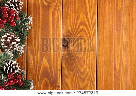 Spruce Branches, Cones And Red Berries On A White Wooden Background. Background For Christmas And Ne