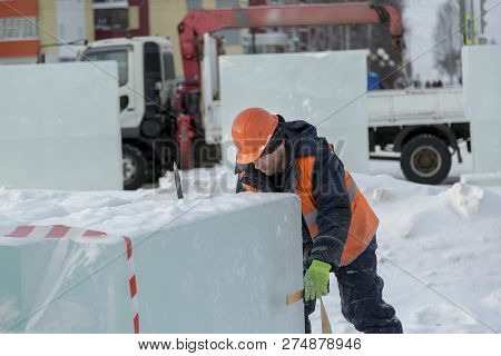 Slinger In An Orange Helmet On Unloading Ice Blocks
