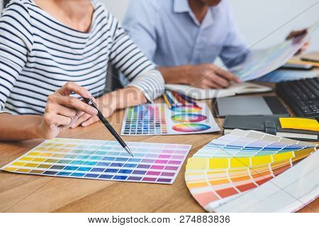 Two Colleagues Creative Graphic Designer Working On Color Selection And Drawing On Graphics Tablet A