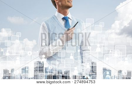 Double Exposure Of Confident And Young Businessman In Smart-casual Wear Smoking Pipe And Modern City