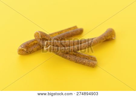 Detail Of Pasta Casarecce Of Legume With Yellow Background