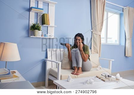 Emotional Young Hispanic Woman Crying After Watching Melodrama On Tv