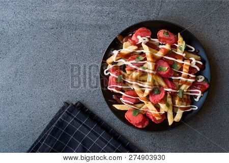Homemade Peruvian Salchipapa Fries With Sausage Slices, Ketchup And Mayonnaise.