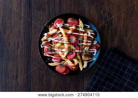 Homemade Peruvian Salchipapa Fries With Sausage Slices, Ketchup And Mayonnaise.