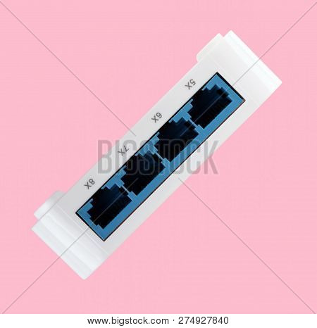White 8 Port Plastic Ethernet Switch Isolated On Pink Background At Dry Day