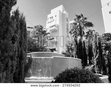 Residential Buildings And Fountain Surrounded With Green Plants In  Rishon Le Zion.
