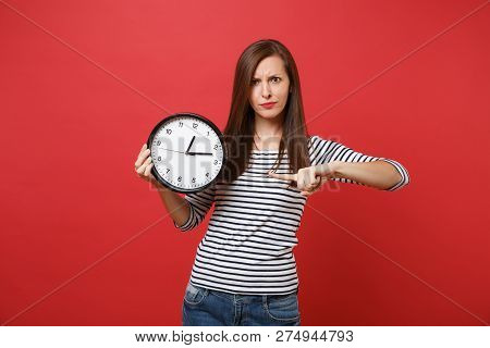 Concerned Strict Young Woman Pointing Index Finger On Round Cloc