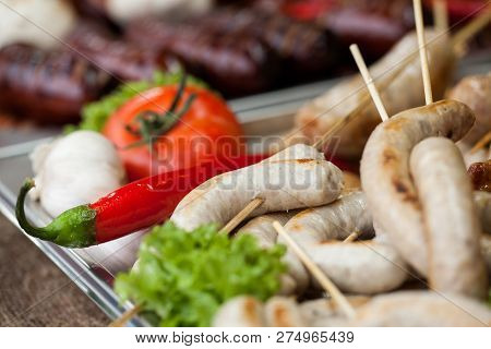 Delicious Grilled Sausages And Vegetable. Pork Sausages Fried In The Fire.