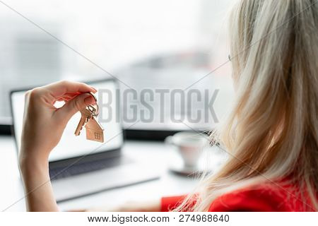 Mortgage Concept. Woman In Red Coral Business Suit Holding Key With House Shaped Keychain. Modern Li