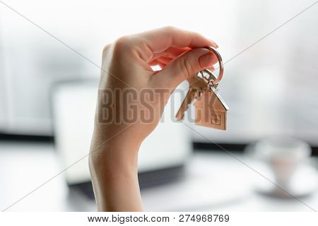 Mortgage Concept. Woman In Red Coral Business Suit Holding Key With House Shaped Keychain. Modern Li