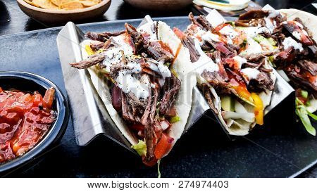 Mexican Tacos With Beef And Salsa / Dip  Sauce At The Bar Outside.
